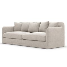 an image of a couch with pillows on the top and bottom half, in light grey linen