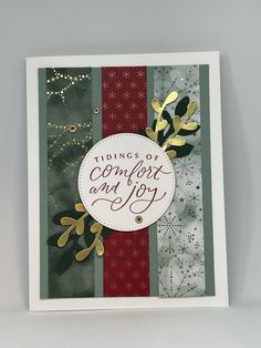 a christmas card with gold foil and red, green, and white stripes that says puddings of comfort and joy