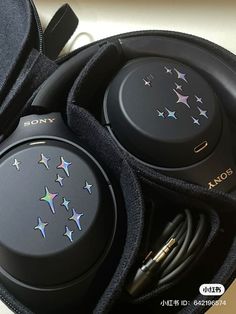 a pair of headphones in a case with stars on them and earbuds