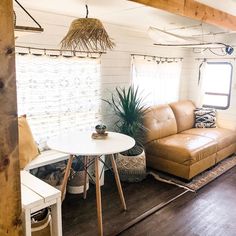 a living room filled with furniture next to a wooden table and chair in front of a window