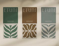 three different labels with leaves on them are shown in the same color and font pattern