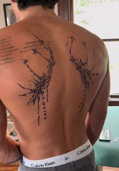 the back of a man's body with writing on it