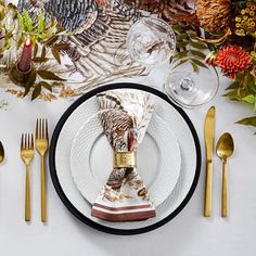 a thanksgiving place setting with turkey napkins and silverware