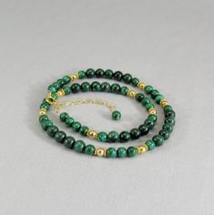 Vibrant green polished malachite beads in two sizes are interspersed with decorative vermeil spacers and shiny 14 karat gold filled beads. This statement necklace closes with a gold filled spring ring and adjustable chain for a finished length of 18 to 20 inches (46 to 51 cm). You can choose the shorter length of 16 to 18 inches (41 to 46 cm) if you prefer. Gorgeous bright green gemstone beads and quality findings make this necklace perfect for career wear and special evenings. The adjustable le Green Malachite Beaded Necklaces With Natural Stones, Green Malachite Beaded Necklace With Natural Stones, Green Malachite Gemstone Beads Necklace, Green Malachite Gemstone Bead Necklaces, Green Malachite Jewelry With Gemstone Beads, Green Malachite Gemstone Bead Jewelry, Malachite Necklace With Natural Round Beads, Malachite Natural Stones Round Beads Necklace, Elegant Beaded Malachite Necklaces