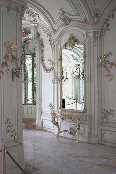 an ornately decorated room with white walls and marble floors