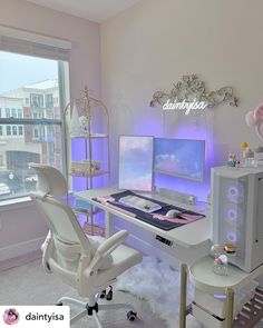 a desk with a computer and chair in front of a window