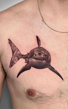 a man's chest with a shark tattoo on it