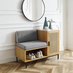 a pair of shoes are sitting on a bench in front of a mirror and shelf