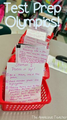 a red basket filled with post it notes on top of a table next to a pile of books