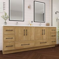 a bathroom with two mirrors above the sink and wood flooring on the side wall