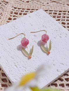 Introducing our exquisite collection of resin tulip drop earrings, a delightful fusion of elegance and charm. These earrings are meticulously crafted to capture the essence of delicate tulip blossoms, making them a perfect accessory for any occasion. With a drop height of approximately 1.1 inches, these earrings gracefully dangle from your ears, creating an eye-catching movement that enhances your every gesture. The total height of 1.5 inches ensures that they make a subtle statement without ove Elegant Resin Flower Shaped Earrings, Elegant Resin Flower Earrings, Elegant Resin Flower-shaped Earrings, Elegant Pressed Flowers Earrings For Mother's Day, Elegant Resin Earrings With Pressed Flowers, Elegant Pressed Flower Resin Earrings, Elegant Resin Birth Flower Earrings, Tulip Earrings, Multicolor Earrings