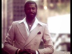 a man wearing a suit and tie standing in the street