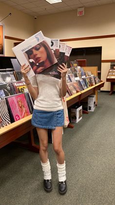 a woman holding up a magazine in front of her face