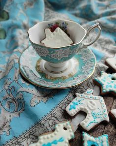 tea cup and saucer decorated with sugar cookies