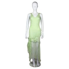 John Galliano silk dress in mint green, from the Fall/Winter 1995 'Delores' collection, a tribute to the Mexican actress Dolores del Rio. As seen on the runway. The dress features beautifully constructed ruffles of silk chiffon and a draped chain on the back. Condition Good. Due to the age and delicate nature of the fabric there are some minor flaws, 2 of the seams have slight wear. A couple of very faint marks only visible upon close inspection. The charm on the back has possibly been re attach John Galliano Wedding Dress, Galliano Wedding Dress, Vintage Galliano, Galliano Dress, Mint Outfit, Green Silk Dress, Green Silk Dresses, Mexican Actress, Moda Paris