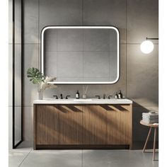 a bathroom vanity with two sinks and a large mirror over the sink in front of it