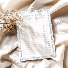 a white sheet with blue writing on it next to a flower and a question card