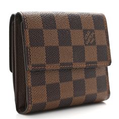 This is an authentic LOUIS VUITTON Damier Ebene Elise Wallet. This stylish wallet is crafted of Louis Vuitton signature damier check canvas. The wallet opens with a flap and a snap to a currency compartment and a flap on the reverse to a brown cross-grain leather interior of card slots, patch pockets and a billfold. Louis Vuitton Damier Ebene, Damier Ebene, Leather Interior, Authentic Louis Vuitton, Louis Vuitton Damier, Patch Pocket, Card Slots, Slots, Grain