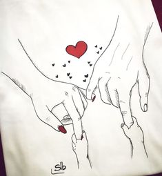 two hands holding each other with hearts drawn on them