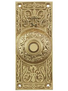 an ornate brass door handle on a white background