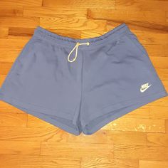 Blue Relaxed Fit Athletic Shorts With Drawstring, Blue Drawstring Shorts For Leisure, Blue Drawstring Leisure Shorts, Leisure Blue Drawstring Shorts, Nike Bottoms With Built-in Shorts For Leisure, Blue Leisure Athletic Shorts, Nike Spring Bottoms With Drawstring, Nike Blue Bottoms For Leisure, Nike Blue Leisure Bottoms