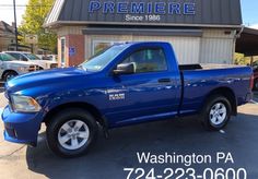 a blue truck parked in front of a building