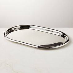 an oval metal tray sitting on top of a white counter