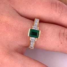 Ladies style Emerald-cut Colombian Emerald mounted in 18k solid yellow gold ring setting with baguette-cut diamond accents. A superb quality Emerald with a vivid, deep green, color hue. The Emerald is mounted in a half-bezel elevated setting, giving the optics of a larger carat size.   Certificate of appraisal included upon request.        Ring Details:  ✔ Ring Size: 8 U.S. (adjustable)  ✔ Ring Weight: 6.5 grams ✔ Gold Purity: 18K   Emerald Details:  ✔ Natural mined Emerald ✔ Cut: Emerald  ✔ Wei Classic Green Baguette Cut Diamond Ring, Baguette Cut Emerald Ring For May Birthstone, Green Emerald Baguette Cut Diamond Ring, Classic Green Emerald Ring With Baguette Diamonds, Green Emerald-cut Diamond Ring Channel Set, Classic Green Diamond Ring With Baguette Diamonds, Green Emerald Cut Diamond Ring Channel Set, Yellow Gold Emerald Ring With Baguette Diamonds, Classic Baguette Cut Green Emerald Ring