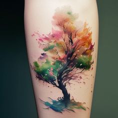 a colorful tree tattoo on the leg