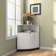 a vase with flowers on top of a white cabinet in a green room next to a window