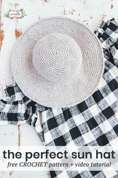 a white hat sitting on top of a black and white checkered dress next to a straw hat