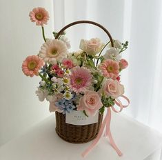 a basket filled with lots of flowers on top of a table