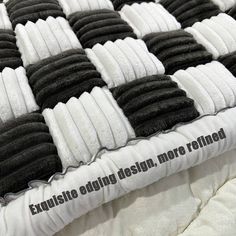 a close up of a mattress with black and white squares on it that says exquisite bedding design more refileded