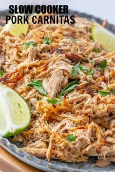 shredded pork with limes and cilantro on a plate