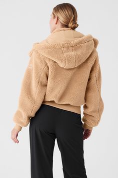 Done in plush sherpa, the Foxy is your new go-to layer. It has a removable hood, a tall collar, a front zipper and cozy ribbing at the cuffs and hem. Fitwise, it’s relaxed with a hip-length hem. Wear it with a cute skirt on the weekend, with sneakers to catch a flight, or over a matching set to walk to your workout. Seriously—it’s that versatile. Black Korean Outfit, Long Sleeve Faux Fur Coat, Faux Fur Coat Black, Jacket For Winter, Black Korean, Black Faux Fur Coat, Fluffy Jacket, Cute Skirt, Woman Back