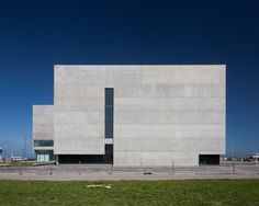 the building is made out of concrete and has two large windows on each side of it