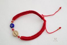 Keep the Patron Saint of Protection close to you, with this handmade St. Benedict bracelet. This bracelet also features a gold saint Benedict medal on a hand woven red thread. The bracelet is adjustable and stretches to fit most wrist sizes. The perfect gift for those who believe in the power of prayer, this bracelet is a reminder that you are never alone and your prayers will be answered. With an image of St. Benedict on it, it's a beautiful and thoughtful gift for those who want to always be m Handmade Adjustable Friendship Bracelets For Blessing, Handmade Adjustable Braided Bracelet For Blessing, Handmade Gold Friendship Bracelets For Gift, Adjustable Red Rosary Bracelet For Friendship, Handmade Adjustable Rosary Bracelet For Blessing, Red Handmade Adjustable Rosary Bracelet, Handmade Red Bracelets For Blessing, Handmade Red Bracelet For Blessing, Adjustable Red Rosary Bracelet