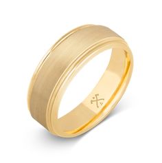 a yellow gold wedding ring with an engraved cross on the center and two lines in the middle