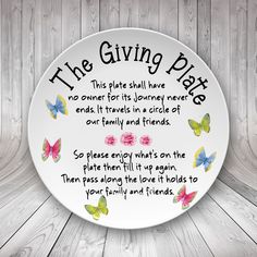 a white plate with butterflies on it that says the giving plate