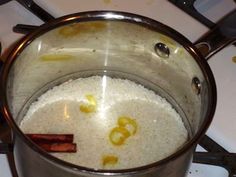 a pot filled with rice and spices on top of a stove