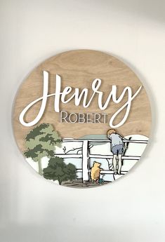 a wooden sign hanging on the side of a wall with a drawing of a person and dog