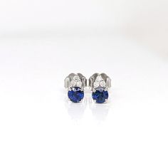 These beautiful stud earrings feature a pair of 0.45 carat weight Blue Sapphire gemstones with natural earth mined diamonds set in solid 14K gold. These Blue Sapphire studs make a lovely September birthstone gift for your loved ones! These earrings are made with solid 14k Gold and natural earth mined SI / G-H Diamonds. As listed, these earrings are ready to ship. If you're interested in purchasing this setting with a different center stone please message us! Sapphire Diamond Earrings With Prong Setting, White Gold Sapphire Diamond Earrings, Classic Sapphire-colored Cubic Zirconia Diamond Earrings, Sapphire Diamond Earrings With Diamond Accents As A Gift, Sapphire Round Cut Diamond Earrings, Sapphire Diamond Earrings With Accents As Gift, Gift Sapphire Diamond Earrings, Sapphire Earrings In Prong Setting, Diamond White, Sapphire Diamond Round Cut Earrings