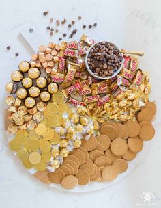 a platter filled with lots of different types of chocolates and candies on top of each other