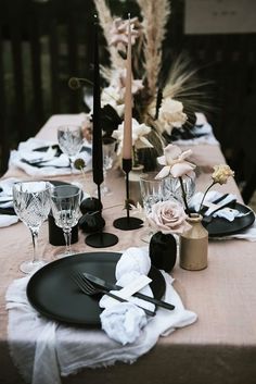 the table is set with black and white place settings