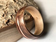 a wooden ring sitting on top of an open book