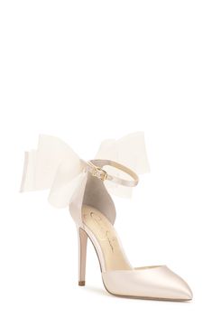 a white high heel shoe with a bow on the ankle