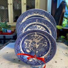 a stack of blue and white plates sitting on top of a table