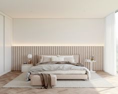 a bedroom with a bed, nightstands and large glass doors leading to the outside