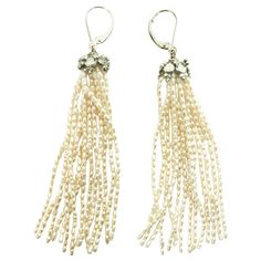 These white rice pearl tassel earrings with 14k white gold lever-backs with a silver rhodium-plated cup are lush and elegant. Flowing out of the roundel are strands of beautiful white rice pearls. At almost 3.5 inches inches, these earrings are timeless and striking, a stable of any jewelry collection, and perfect for almost any formal outfit. The shape of the pearls allows for a beautiful glow in shimmer in the light. Rice Pearl Earrings, Mabe Pearl, White Gold Chains, White Rice, Pearl Earrings Dangle, Pearl Diamond, Rose Cut Diamond, Tassel Earrings, White Gold Diamonds