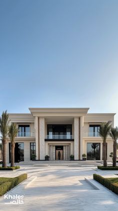 a large white building with lots of windows and palm trees